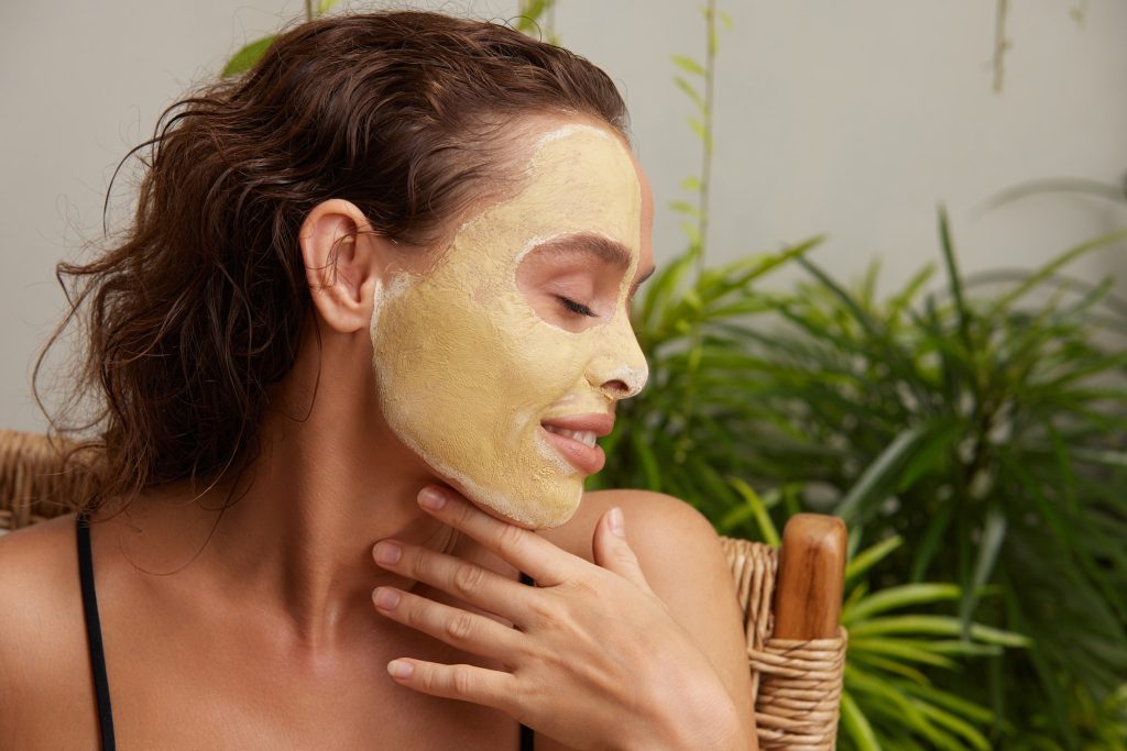 Face Mask Woman. Young Relaxed Woman Enjoying Skin Care Routine at Street