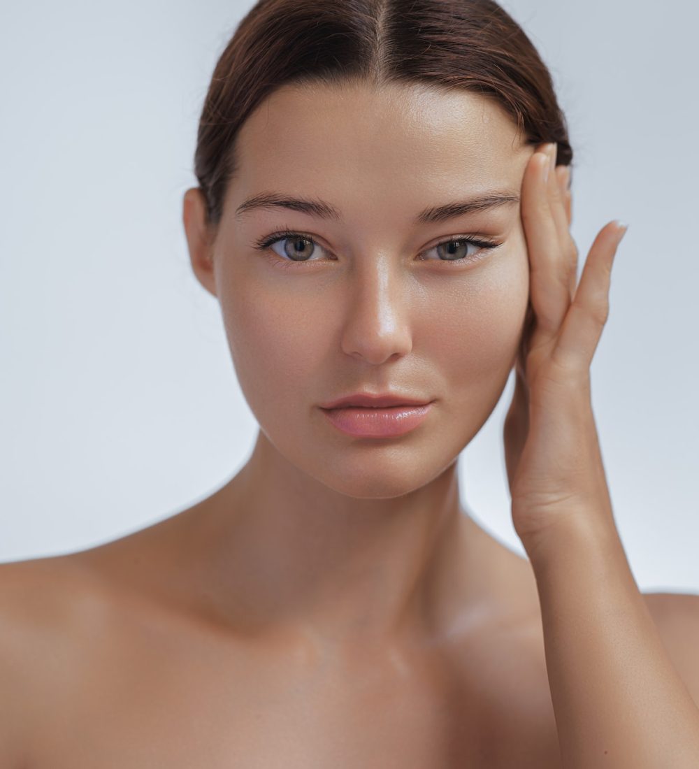 Anti Aging Treatment and Facelift Skin Care Concept. Woman with hand on cheek and eye